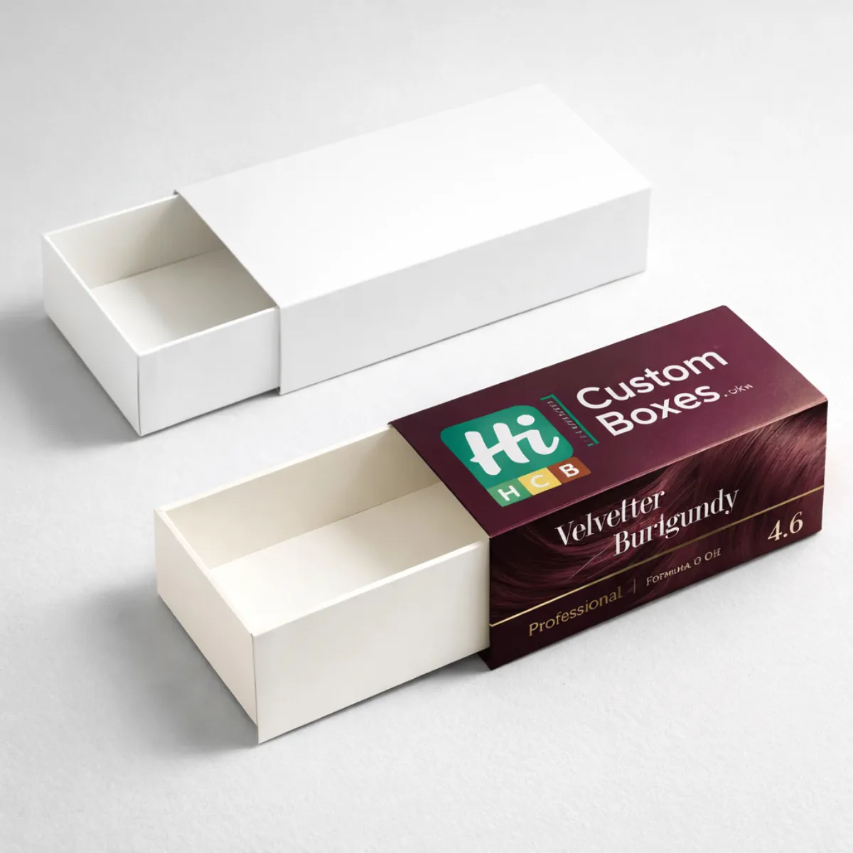 A white drawer-style box next to a custom-printed burgundy hair colour box with a sleeve. class=